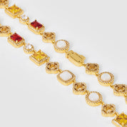 Gold necklace with colored gemstones on a white background